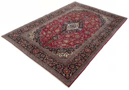 Corner detail of 2000s Kashan rug showing border pattern and Wool pile