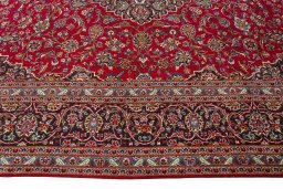 Corner detail of 2000s Kashan rug showing border pattern and Wool pile