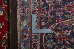 Backside of handmade 2000s Kashan rug showing knot structure and weave density