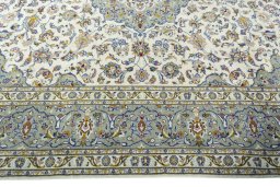 Corner detail of 2000s Kashan rug showing border pattern and Wool pile