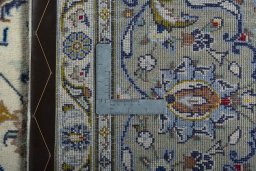 Backside of handmade 2000s Kashan rug showing knot structure and weave density