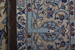 Backside of handmade 2000s Kashan rug showing knot structure and weave density