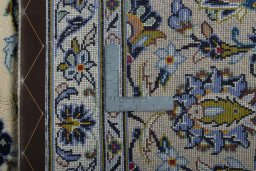 Backside of handmade 2000s Kashan rug showing knot structure and weave density