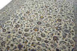 Backside of handmade 2000s Kashan rug showing knot structure and weave density