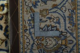 Backside of handmade 2000s Kashan rug showing knot structure and weave density