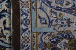 Backside of handmade 2000s Kashan rug showing knot structure and weave density