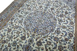 Backside of handmade 2000s Kashan rug showing knot structure and weave density