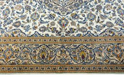 Corner detail of 2000s Kashan rug showing border pattern and Wool pile