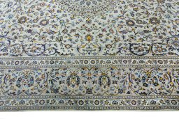Corner detail of 2000s Kashan rug showing border pattern and Cork pile
