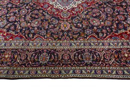 Corner detail of 2000s Kashan rug showing border pattern and Wool pile
