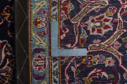 Backside of handmade 2000s Kashan rug showing knot structure and weave density