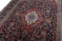 Backside of handmade 2000s Kashan rug showing knot structure and weave density
