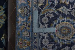 Backside of handmade 2000s Kashan rug showing knot structure and weave density