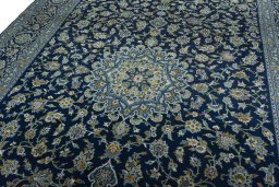 Backside of handmade 2000s Kashan rug showing knot structure and weave density