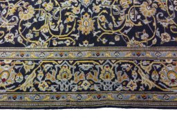 Corner detail of 1970s Kashan rug showing border pattern and Wool pile