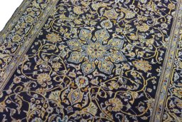 Backside of handmade 1970s Kashan rug showing knot structure and weave density