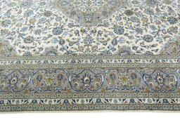 Corner detail of 2000s Kashan rug showing border pattern and Wool pile