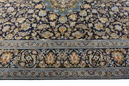 Corner detail of 2000s Kashan rug showing border pattern and Wool pile