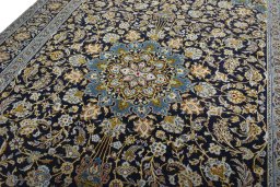 Backside of handmade 2000s Kashan rug showing knot structure and weave density