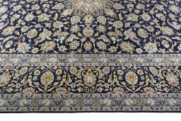 Corner detail of 2000s Kashan rug showing border pattern and Wool pile