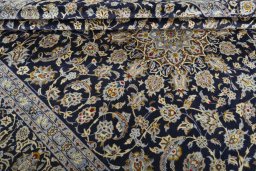 Close-up detail of 2000s Kashan rug from Iran / Persia showing Wool weave
