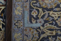 Backside of handmade 2000s Kashan rug showing knot structure and weave density