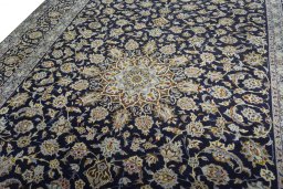 Backside of handmade 2000s Kashan rug showing knot structure and weave density