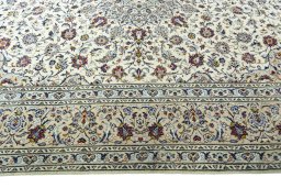 Corner detail of 2000s Kashan rug showing border pattern and Wool pile