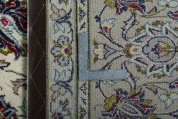 Backside of handmade 2000s Kashan rug showing knot structure and weave density