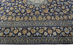Corner detail of 2000s Kashan rug showing border pattern and Wool pile