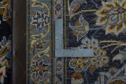 Backside of handmade 2000s Kashan rug showing knot structure and weave density