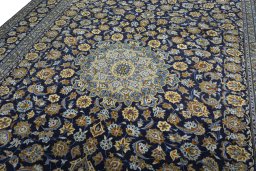 Backside of handmade 2000s Kashan rug showing knot structure and weave density