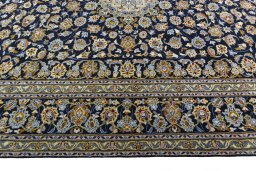 Corner detail of 2000s Kashan rug showing border pattern and Wool pile