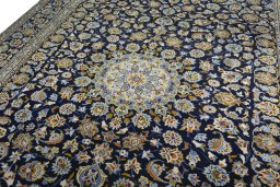 Backside of handmade 2000s Kashan rug showing knot structure and weave density