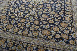 Close-up detail of 2000s Kashan rug from Iran / Persia showing Wool weave