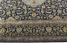 Corner detail of 2000s Kashan rug showing border pattern and Wool pile