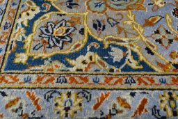 Backside of handmade 2000s Kashan rug showing knot structure and weave density