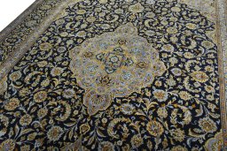 Backside of handmade 2000s Kashan rug showing knot structure and weave density