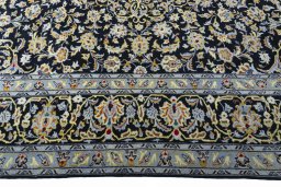 Corner detail of 2000s Kashan rug showing border pattern and Wool pile