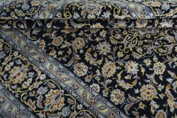 Close-up detail of 2000s Kashan rug from Iran / Persia showing Wool weave
