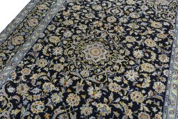 Backside of handmade 2000s Kashan rug showing knot structure and weave density