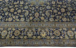 Corner detail of 2000s Kashan rug showing border pattern and Wool pile