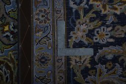 Backside of handmade 2000s Kashan rug showing knot structure and weave density