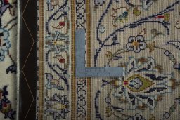 Backside of handmade 2000s Kashan rug showing knot structure and weave density