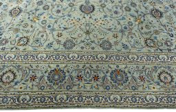 Corner detail of 2000s Kashan rug showing border pattern and Wool pile