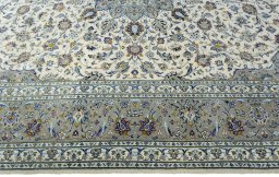 Corner detail of 2000s Kashan rug showing border pattern and Cork pile