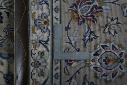 Backside of handmade 2000s Kashan rug showing knot structure and weave density