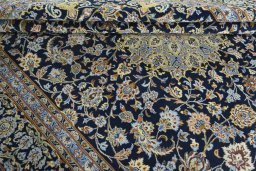 Close-up detail of 2000s Kashan rug from Iran / Persia showing Wool weave