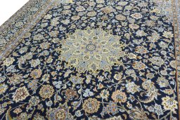 Backside of handmade 2000s Kashan rug showing knot structure and weave density