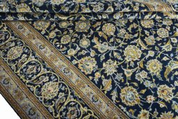 Close-up detail of 2000s Kashan rug from Iran / Persia showing Wool weave